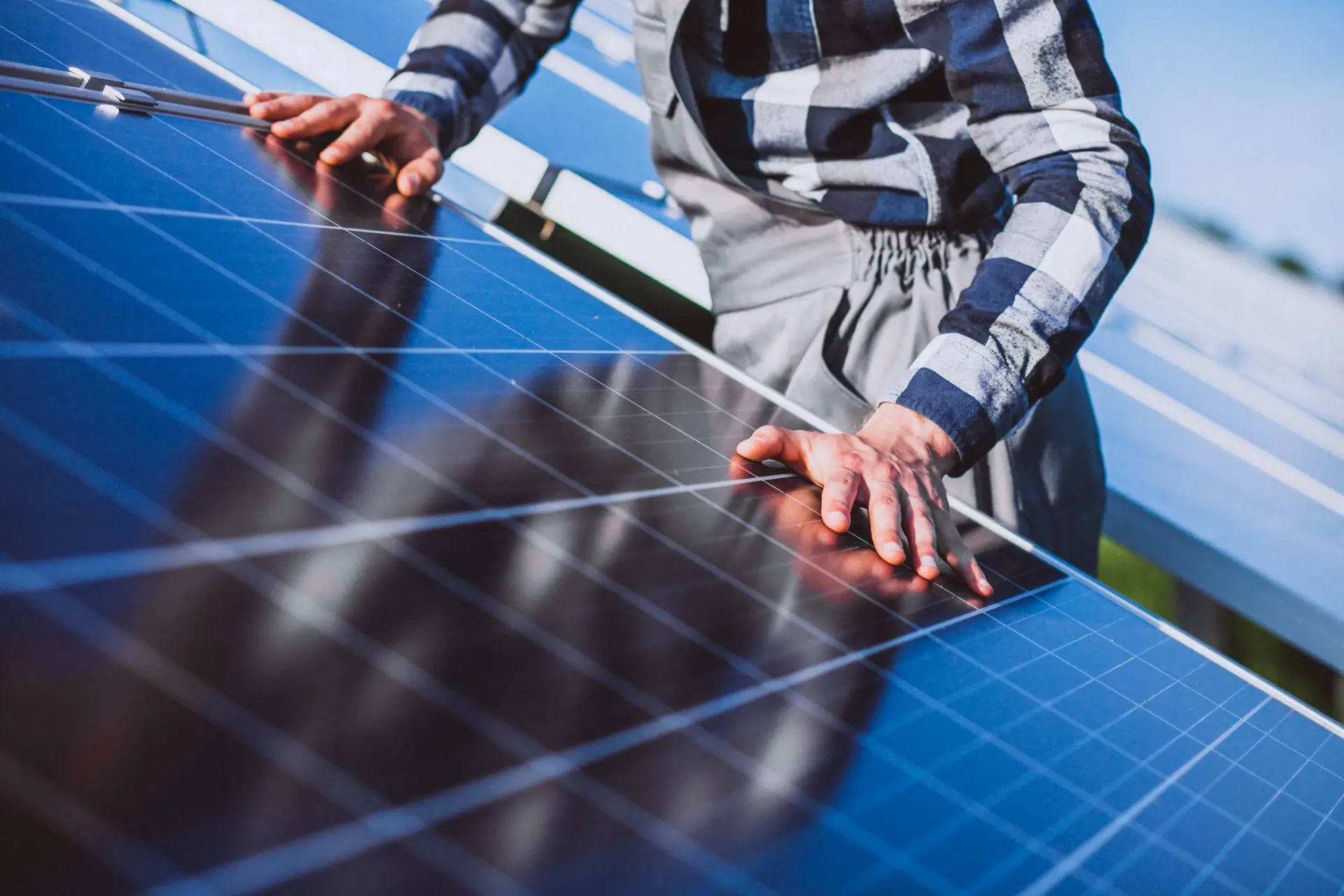 Monteur richtet ein Solarmodul auf dem Dach aus
